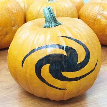 Image of a pumpkin with a galaxy design painted on it.